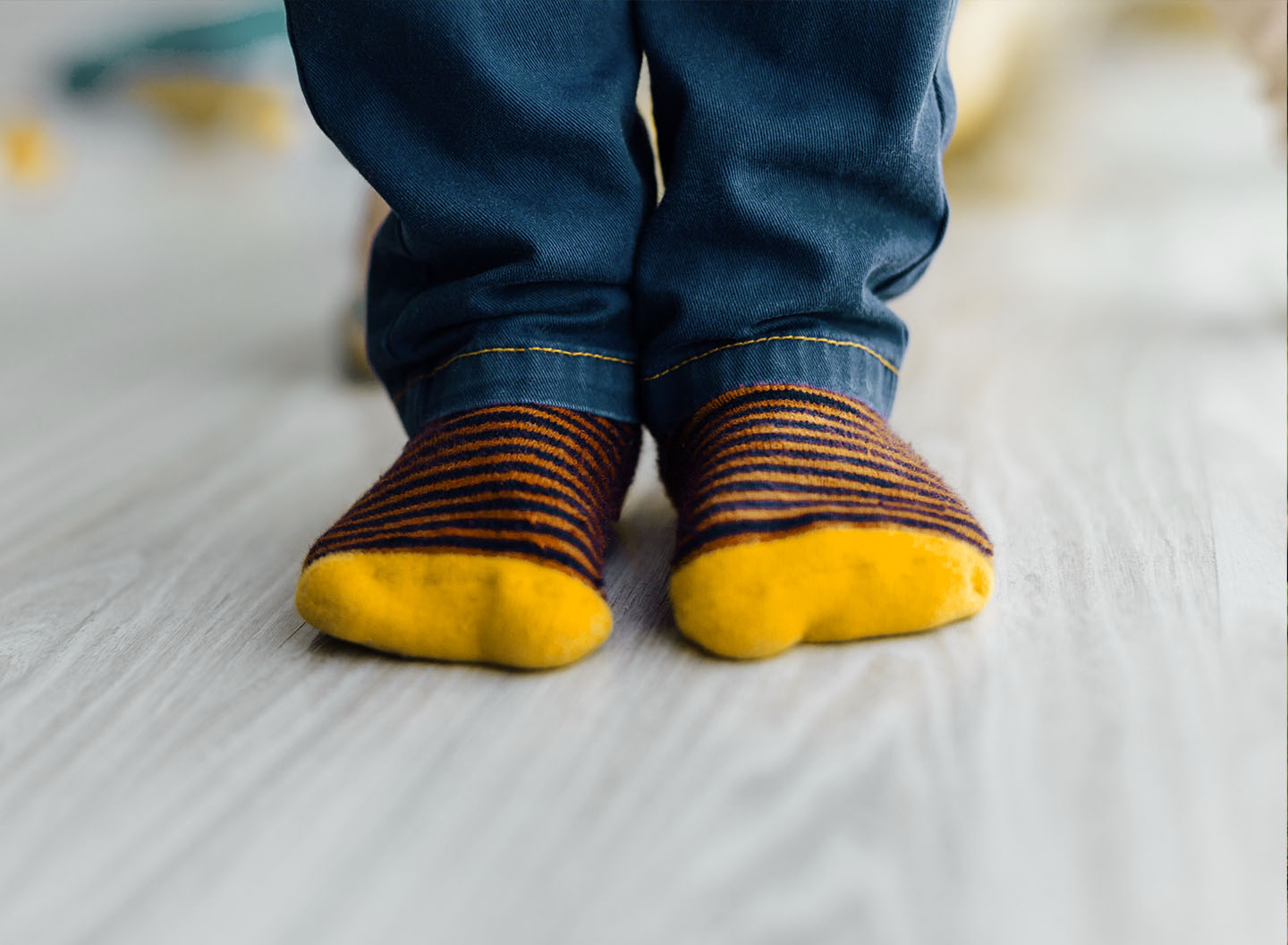 Child wearing striped wool socks for optimal foot climate in GORE-TEX® shoes