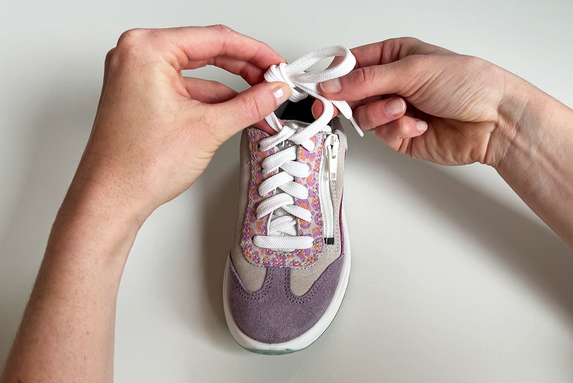 Tying shoelaces using the bunny ears technique from step 4: pull